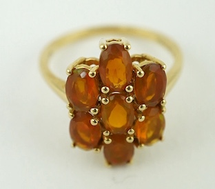 A 10K yellow gold orange stone cluster dress ring, size N, gross weight 2.6 grams. Condition - fair